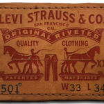 A Levi's® leather patch featuring the Levi's® two-horse pull logo and information about the denim fit.