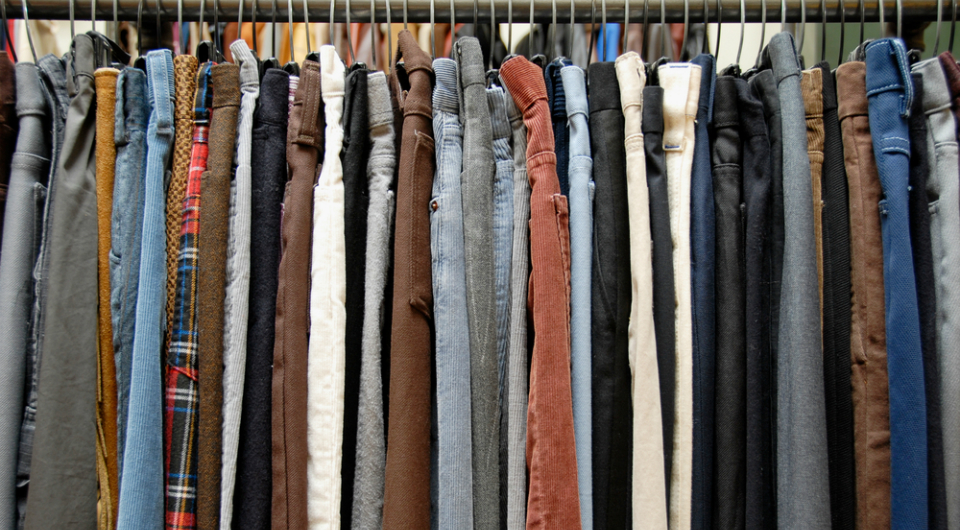 A rack of many Levi's® pants in various shades and textures.
