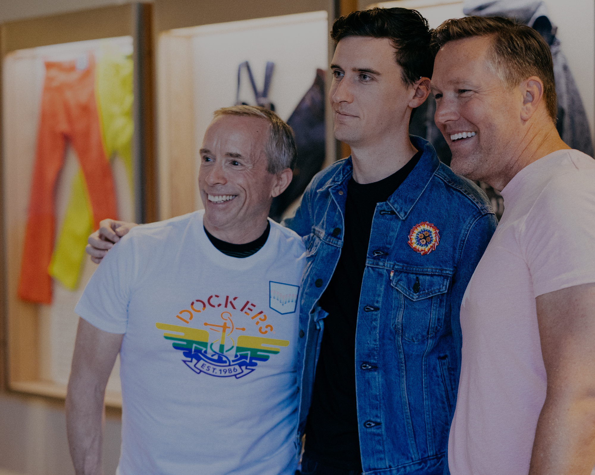 Three LS&Co. employees stand next to each other and smile off to the left of the image