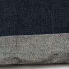 the bottom rolled up cuff of a pair of denim jeans