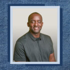 Kenny Mitchell headshot on denim texture background