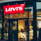 The exterior of Levi's® Century City, featuring a Levi's® logo sign on the top of the front door, opening to products inside.
