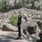 John Wang, LS&Co. vice president of Global Business Development and Licensing, stands on a hiking trail in front of a rocky mountainside.