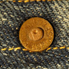 a close up photo of a Levi's metal rivet on denim