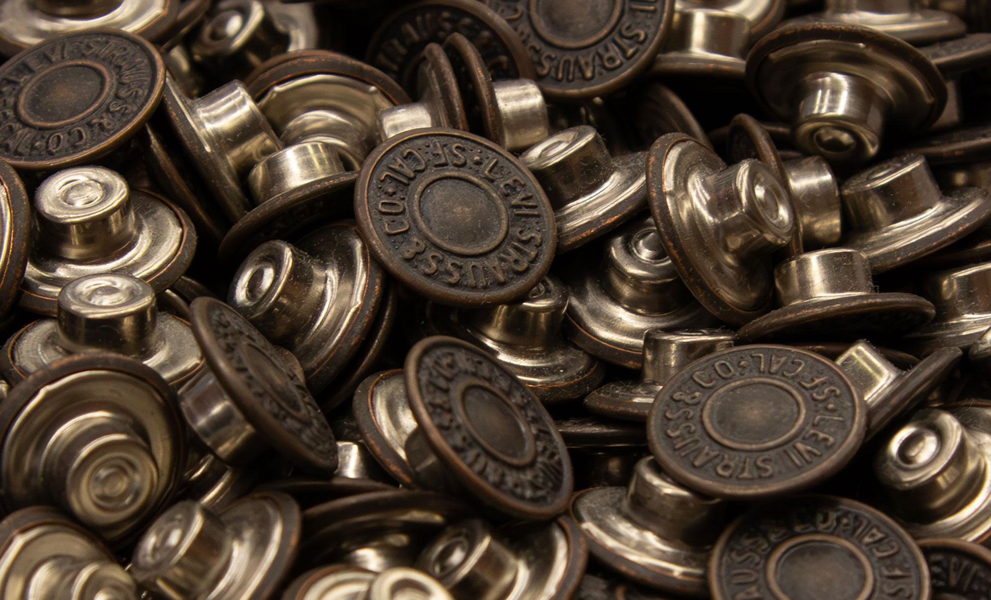 A pile of LS&Co. branded metal buttons