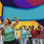 a collage of individuals smiling and cheering in front of a colorful background