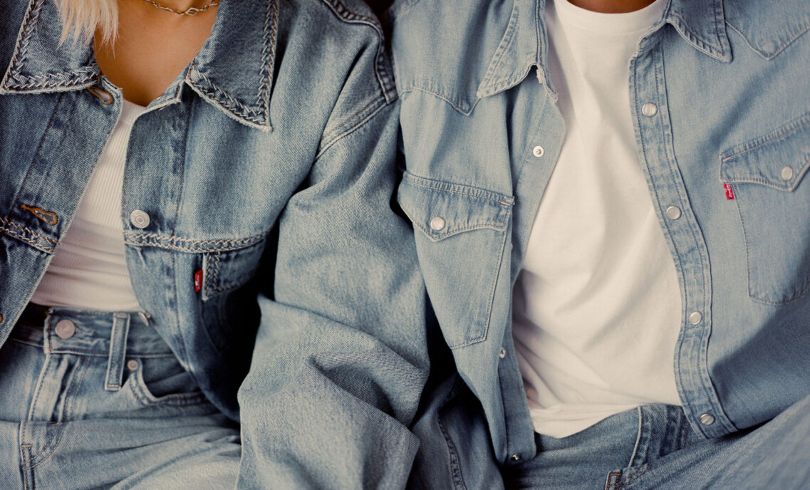 Two figures wear light wash Levi's® denim shirts over white T-shirts and light wash Levi's® denim jeans