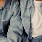 Two figures wear light wash Levi's® denim shirts over white T-shirts and light wash Levi's® denim jeans