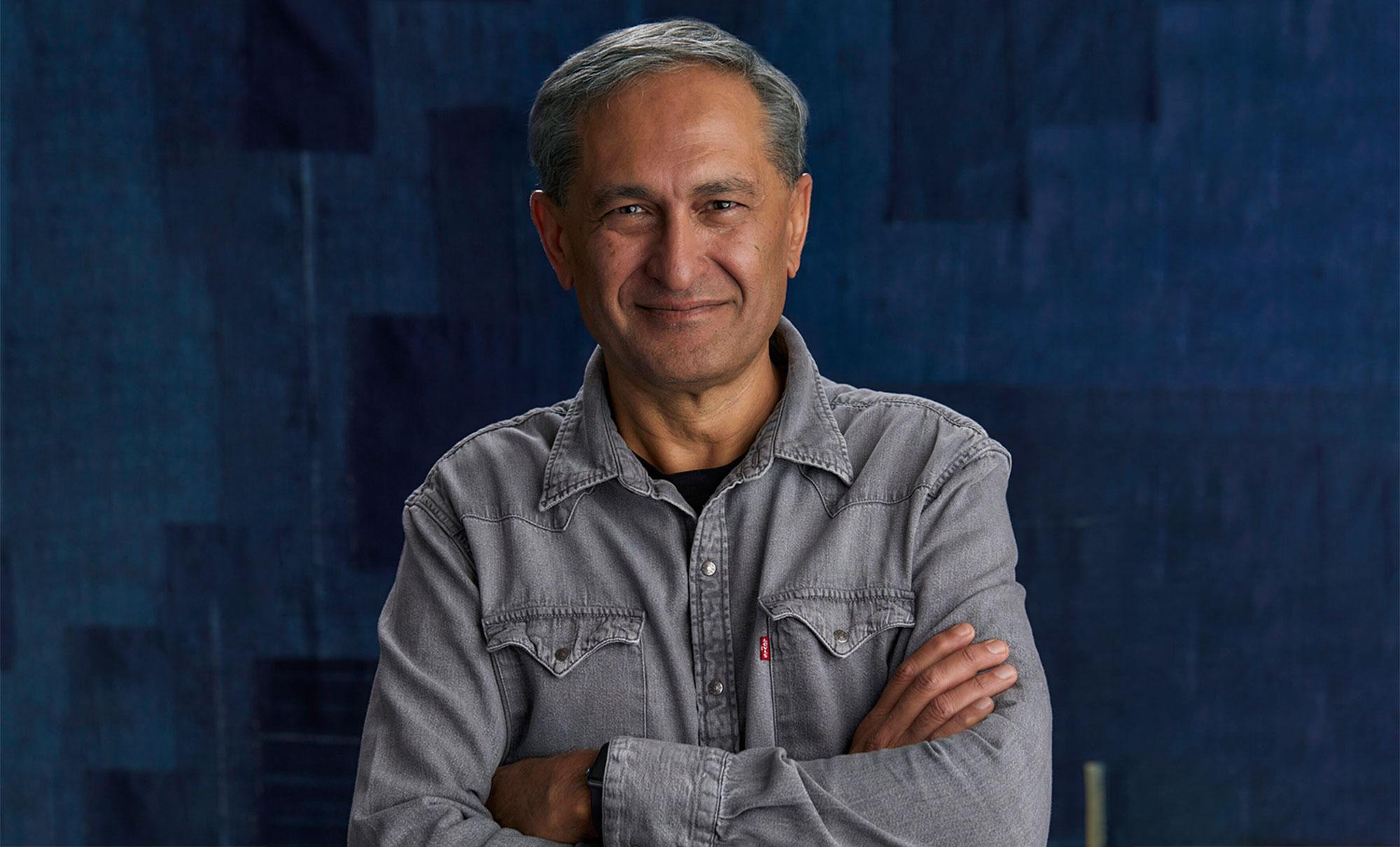 Levi Strauss & Co. Chief Financial and Growth Officer Harmit Singh poses in front of a blue textured background