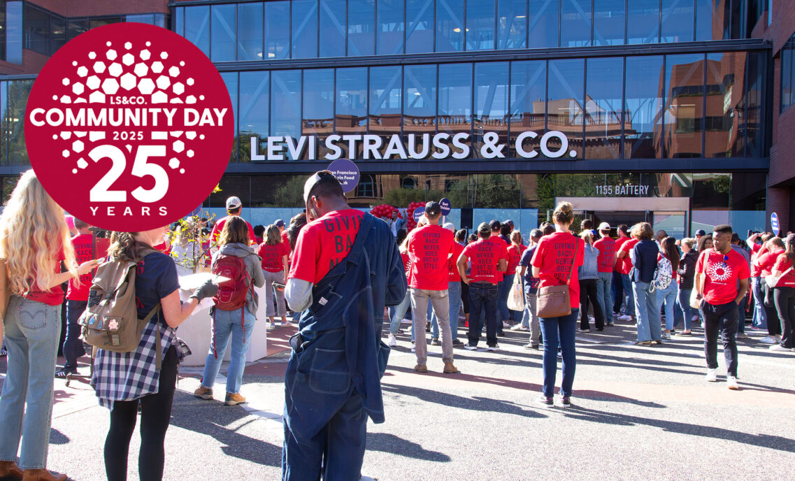 LS&Co. employee volunteers gather around the front of the LS&Co. San Francisco headquarters wearing red volunteer shirts. A red logo in the top left corner reads "Community Day 25 Years"