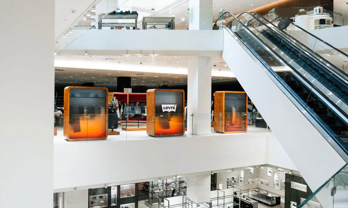 A Levi's® pop-up shop in a Holt Renfrew department store, viewed from the escalator well
