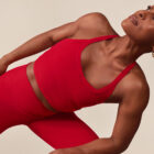 Issa Rae wears a red Beyond Yoga® tank and matching red Beyond Yoga® leggings for Beyond Yoga's Seek Beyond campaign