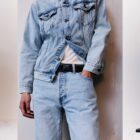 Left: a model stands against a grey backdrop with their hands by their side, wearing a light wash Levi's® denim Trucker jacket and matching Levi's® 501® Thermodapt jeans. Middle: A zoomed in cropped image of the model with a hand in their pocket. Right: the model stands with their hands behind their head.