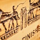 A wood carving of the Levi's® Two-Horse pull logo