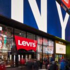 The exterior storefront of Levi's® Times Square, featuring a digital billboard above the store reading "NYC" and a red Levi's® batwing logo above the front door
