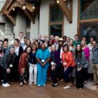Employees from Levi Strauss & Co.'s Red Tab Foundation, the Epic Promise Fund at Vail Resorts and leaders from other companies including Home Depot, HCA Healthcare, Chick-fil-a, Giving Kitchen adn Walmart smile for a group photo in front of a Vail Resorts building facade.