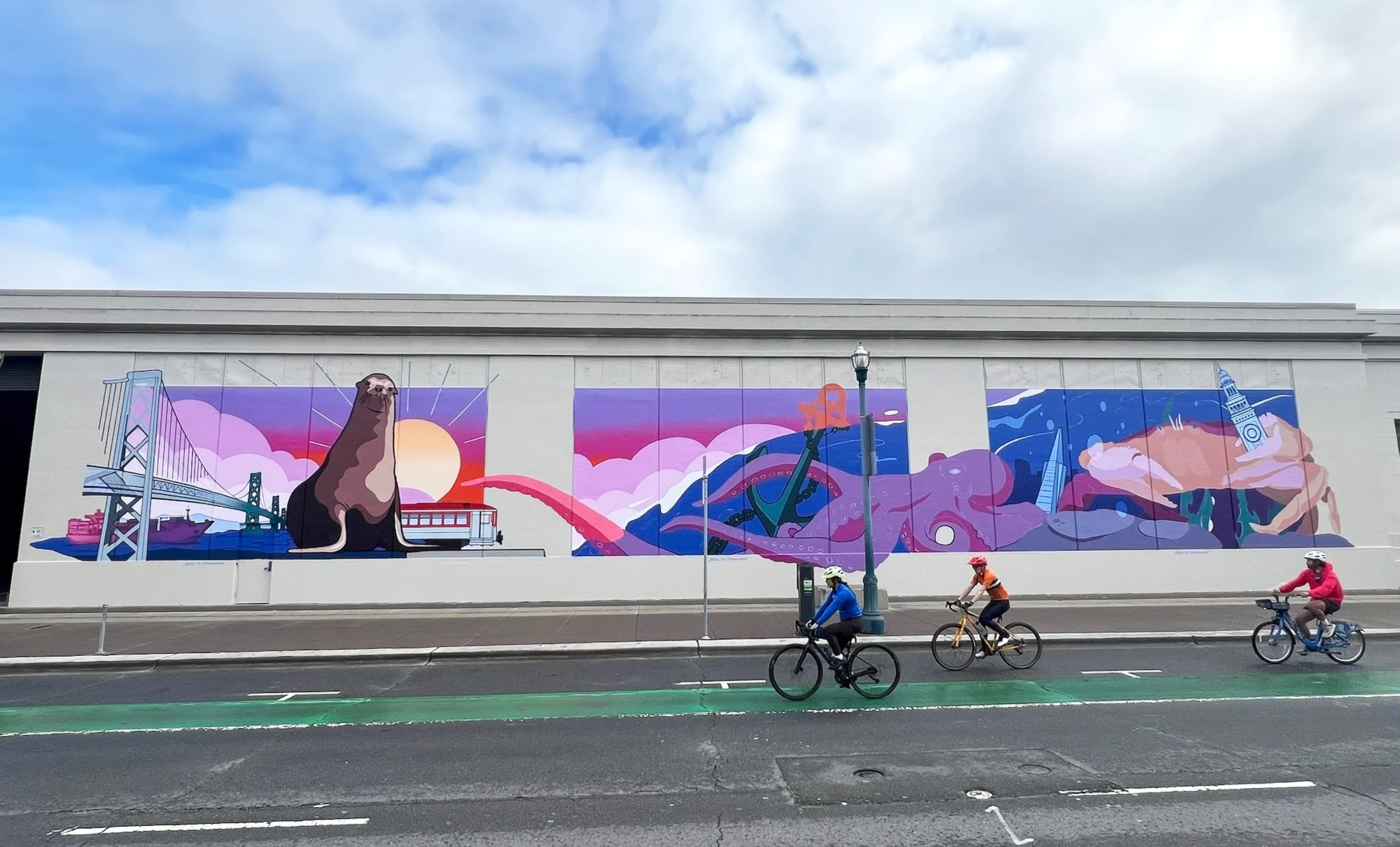 A photo of a mural on San Francisco's Embarcadero, featuring San Francisco maritime icons