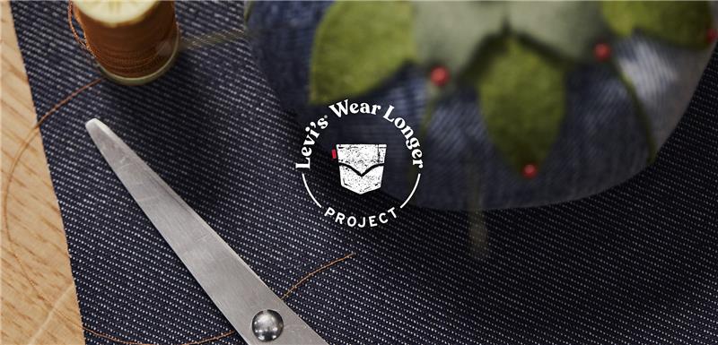 a white logo reading "Levi's® wear longer project" overlaid on top of an image of a piece of denim, sewing scissors and a denim pin cushion. White text reads "repair, refresh and reimagine your clothes"