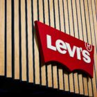A cropped image of a Levi's® storefront, featuring the Levi's® batwing logo on top of wooden slats.